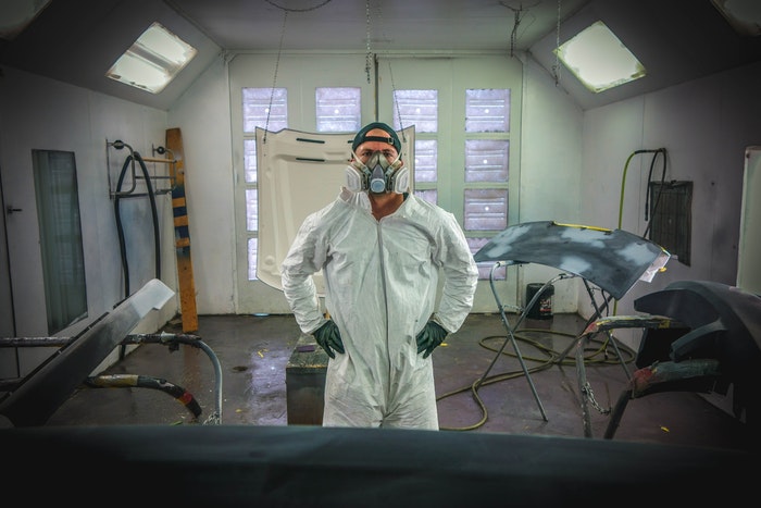 man with breathing mask and ppe to avoid asbestos exposure